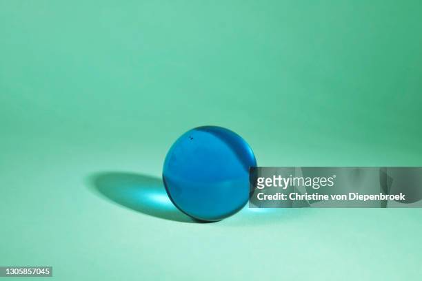 translucent shiny glass objects on plain background - magic ball stockfoto's en -beelden