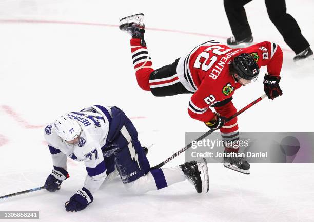 Ryan Carpenter of the Chicago Blackhawks is tripped by Victor Hedman of the Tampa Bay Lightning in the second period at the United Center on March...