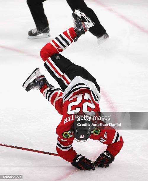 Ryan Carpenter of the Chicago Blackhawks hits the ice after being tripped by Victor Hedman of the Tampa Bay Lightning in the second period at the...