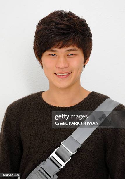 Lee Yong-Chan a Korea university student, poses for photographs at Korea University in Seoul on October 27, 2011. The world's population will surge...