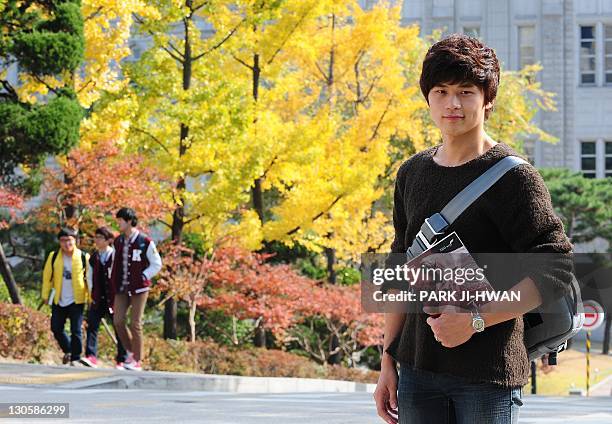 Lee Yong-Chan a Korea university student, poses in for photographs at Korea University in Seoul on October 27, 2011. The world's population will...