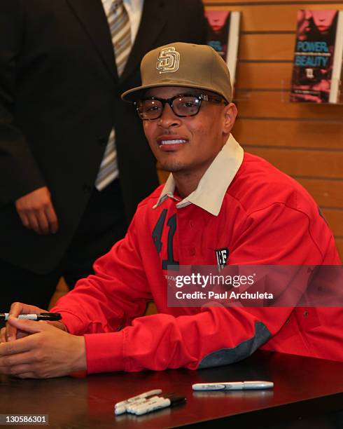 Harris With Rapper Rapper T.I. Harris signs copies of his new book
