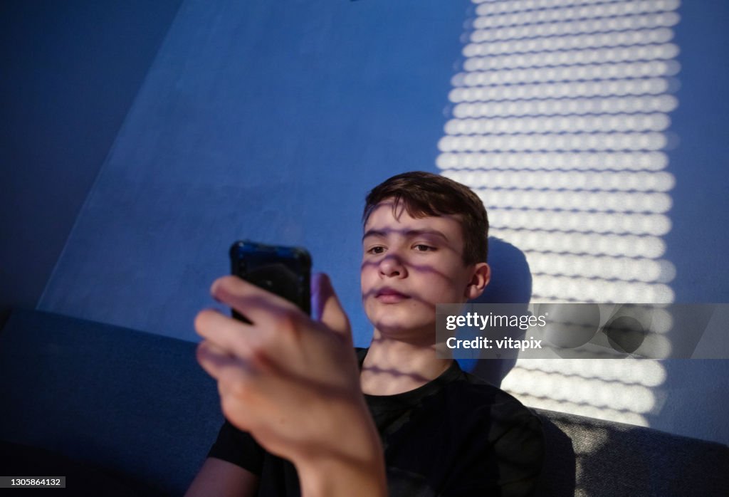 Teenager Using Cell Phone at Night