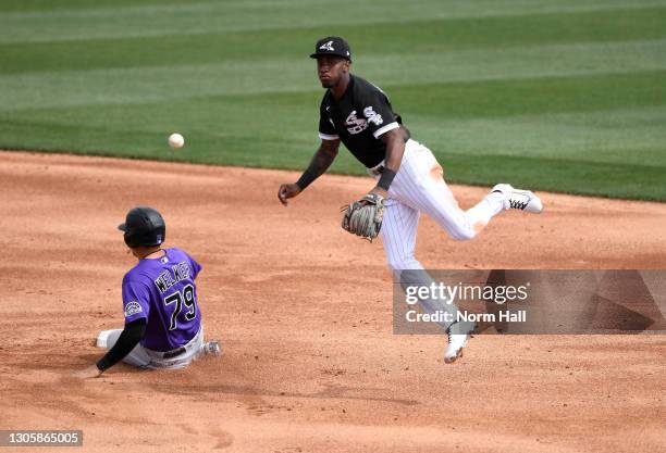 Tim Anderson of the Chicago White Sox attempts to turn a double play on a ground ball hit by Ryan Vilade of the Colorado Rockies as Colton Welker is...