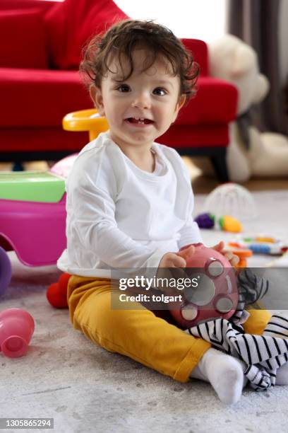 baby girl with piggy bank - save our future babies stock pictures, royalty-free photos & images