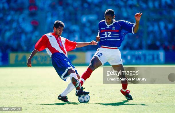 Thierry Henry of France and Francisco Arce of Paraguay in action during the World Cup round of 16 match between France and Paraguay at the Stade...