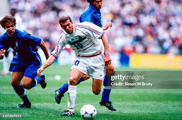 Zinedine Zidane of France and Demetrio Albertini and Fabio Cannavaro of Italy in action during the World Cup quarter final match between France and...