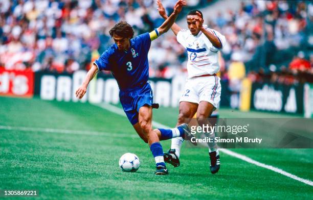 Thierry Henry of France and Paolo Maldini of Italy in action during the World Cup quarter final match between France and Italy at the Stade de France...
