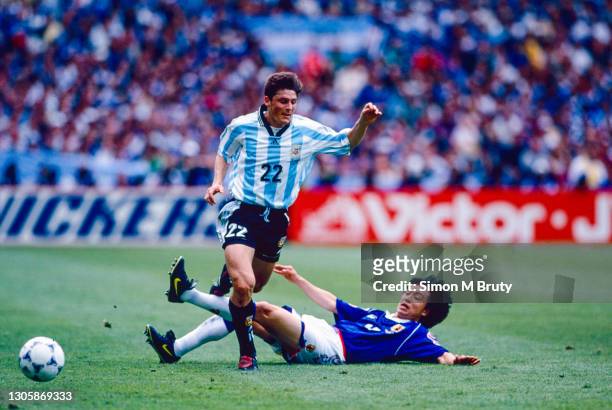 Javier Zanetti of Argentina and Wagner Lopes of Japan in action during the World Cup 1st round match between Argentina and Japan at the Stade de...