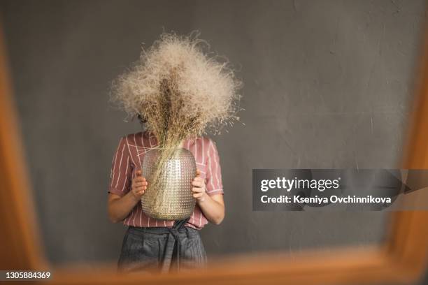 woman holding a bunch of dyed gypsophila bouquet of flowers. concept for wedding, gift, valentine's day, birthday, graduation, pureness, freedom, innocence, newborn, background - small wedding fotografías e imágenes de stock