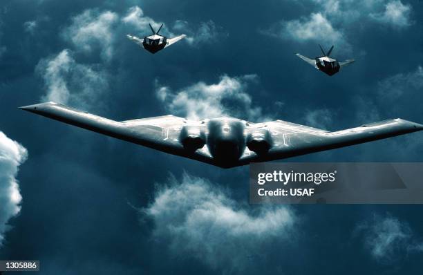 Spirit bomber, center, flies with two F-117A Nighthawks, July 19, 2000 above dramatic clouds. The B-2 Spirit is a multi-role bomber capable of...