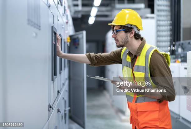 electrician working at electrical room - control room stockfoto's en -beelden