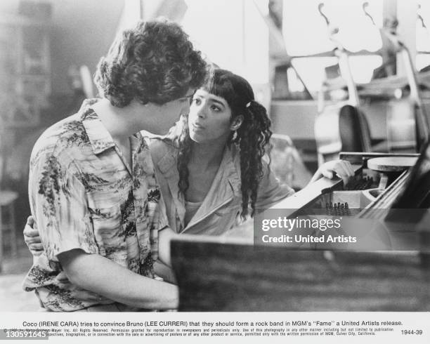 Bruno Martelli tries to convince Coco Hernandez that they should form a rock band, in a scene from 'Fame', directed by Alan Parker, 1980.