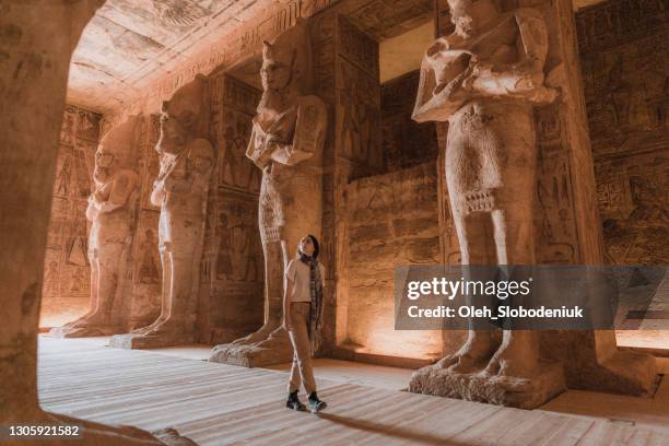 woman walking inside abu simbel temples - egito imagens e fotografias de stock
