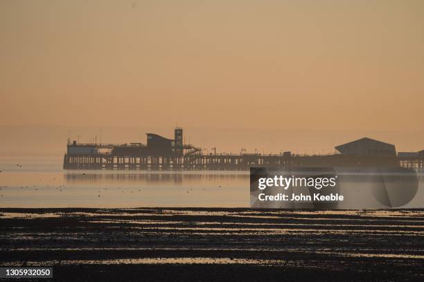 General view of Southend pier as the sun goes down at low tide on February 27, 2021 in Southend-on-Sea, England.