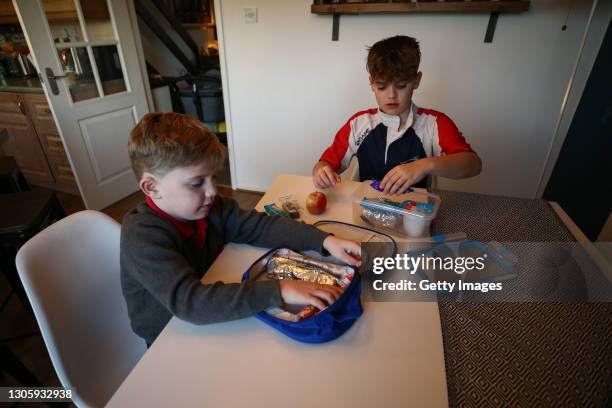 Taylor Hoare and Colby Hoare pack their lunchboxes for school on March 08, 2021 in Truro, England. England's schools re-open to pupils from March...