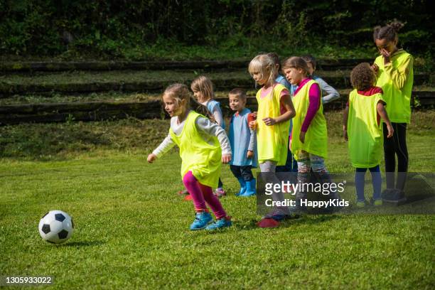 girl practicing during soccer training - kids lining up stock pictures, royalty-free photos & images