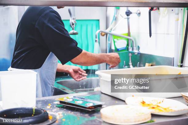 restaurant dish washing staff at work - untidy sink stock pictures, royalty-free photos & images