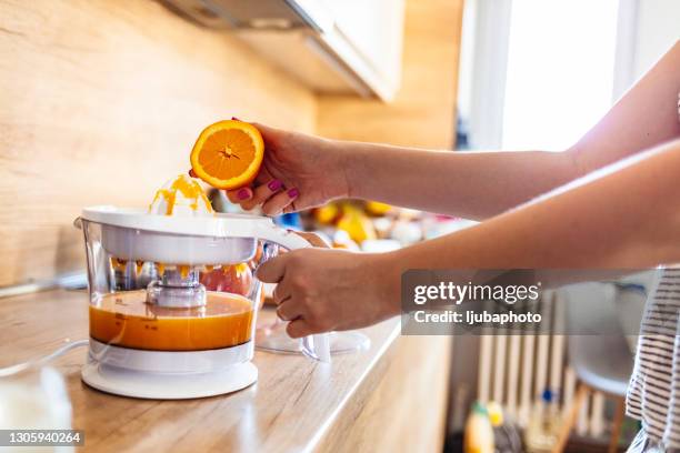 sinaasappels zijn hier om de dag op te fleuren! - woman squeezing orange stockfoto's en -beelden