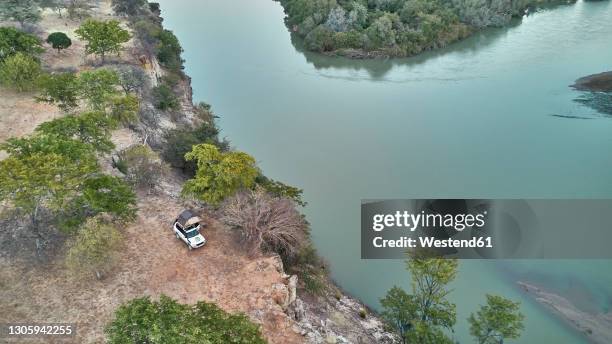 aerial view of a jeep with a rooftop tent, cunene river area, angola - angola drone stock pictures, royalty-free photos & images