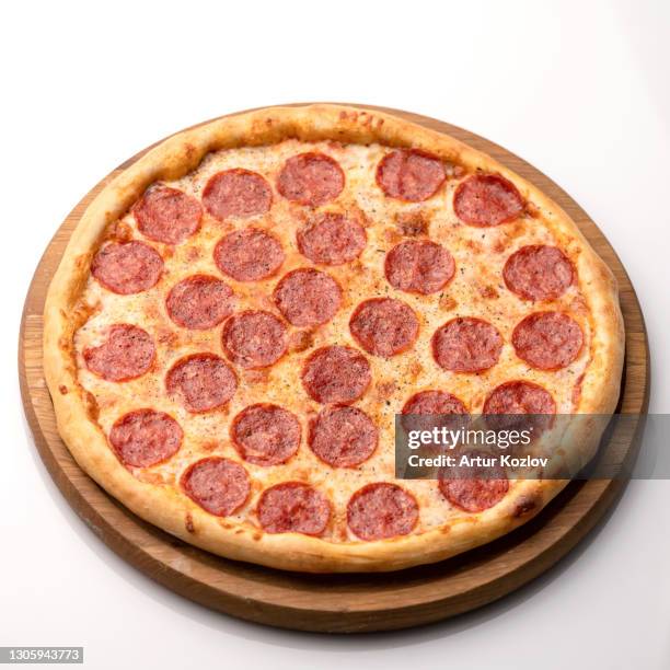 whole paperone pizza on white table background. hot pizza with sausage on wooden board. delicious pizza. traditional italian food, top view. nutrition dinner or lunch. object isolated on white - pizza crust stock pictures, royalty-free photos & images