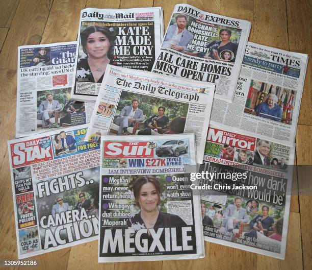 In this photo illustration - a selection of British newspaper publications in response to the Meghan, Duchess of Sussex and Prince Harry, Duke of...