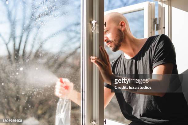 cleaning the windows at home - home cleaning stock pictures, royalty-free photos & images