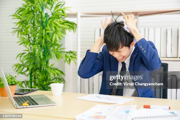 furious angry asian office worker screams in despair at office - faces aftermath of storm eleanor stockfoto's en -beelden