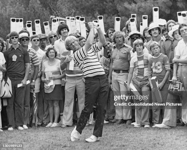 Spectators look on using periscopes to view as Jack Nicklaus of the United States plays an approach shot to the 3rd green during the 58th PGA...