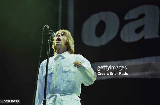 Singer Liam Gallagher performing with British rock group, Oasis, at Knebworth House, Hertfordshire, 10th August 1996.