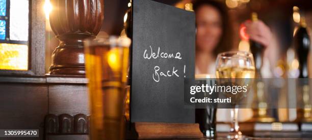 welcome back pub drinkers - pandemic reopening stock pictures, royalty-free photos & images