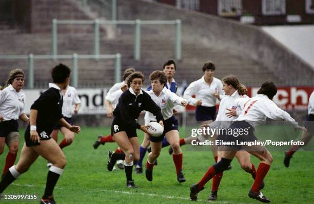 New Zealand player prepares to pass the ball during play between New Zealand and United States in the semi-finals of the 1991 Women's Rugby World Cup...