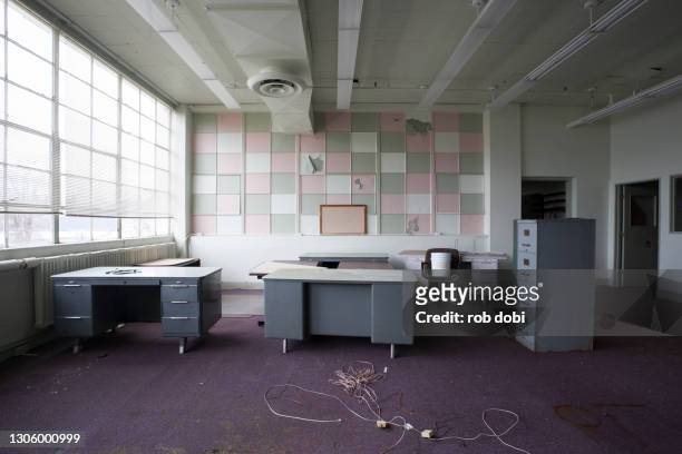 desks inside office section inside an abandoned industrial factory - obsolete stock pictures, royalty-free photos & images
