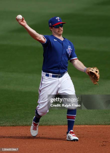 Second baseman Brock Holt of the Texas Rangers throws to first during the second inning of the MLB spring training baseball game against the Los...