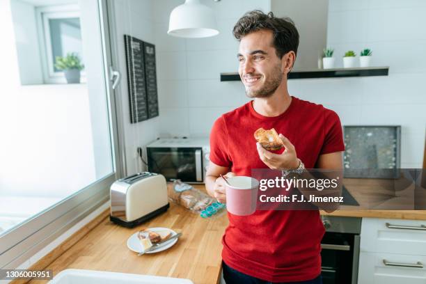 man having breakfast in home kitchen - butter coffee stock pictures, royalty-free photos & images