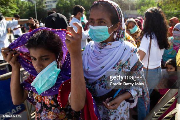 People attend the Aurat March for International Women's Day on March 08, 2021 in Karachi, Pakistan. An end to gender-based violence, sexual...