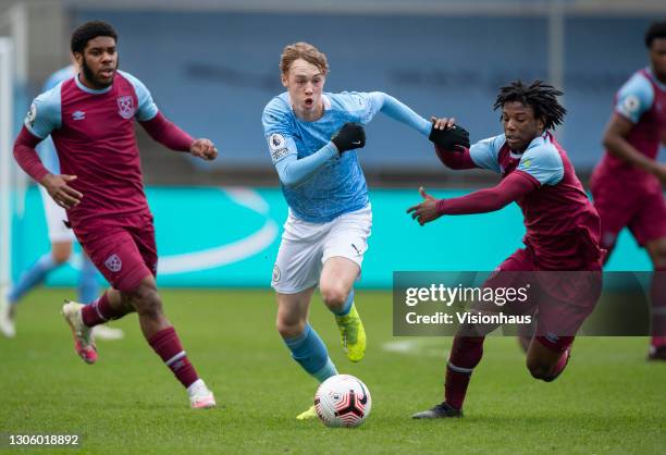 Cole Palmer of Manchester City with Keenan Appiah-Forson and Jayden Fevrier of West Ham United in action during the Premier League 2 match between...