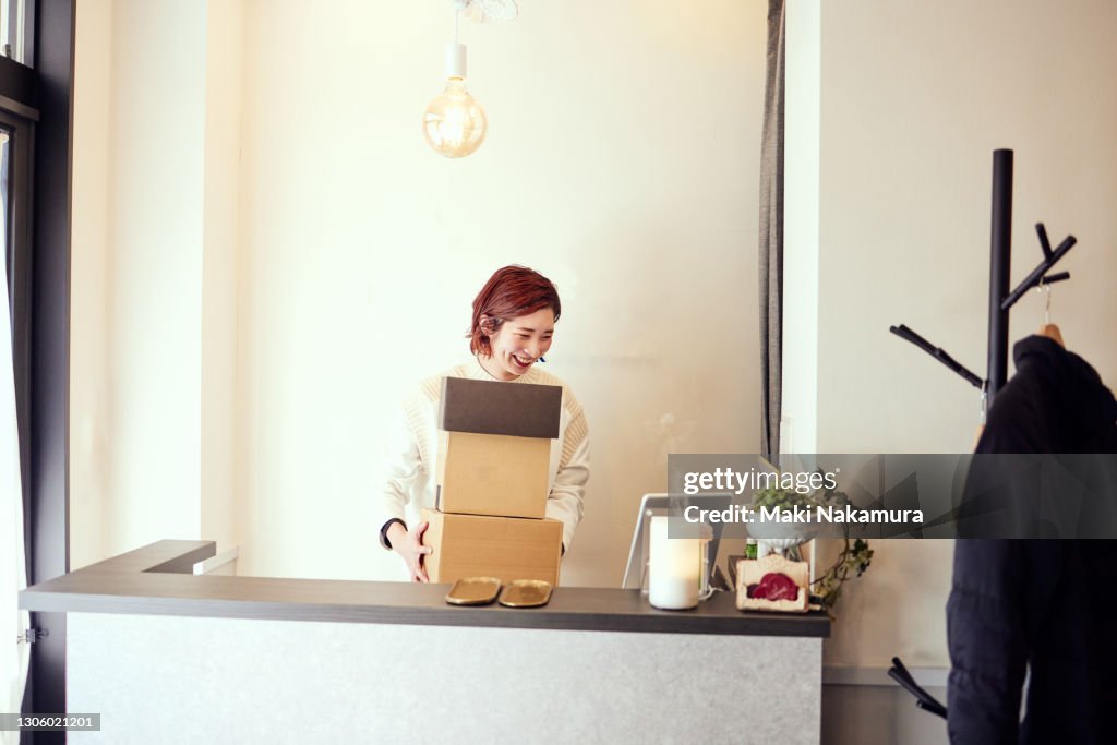 Portrait of a woman trying to receive the package and open the box.