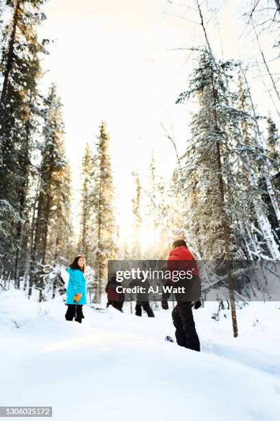 outdoor activity on a winter weekend - kids snowshoeing stock pictures, royalty-free photos & images