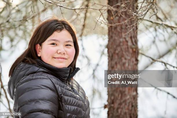 beautiful girl in winter jacket outdoors - native american ethnicity stock pictures, royalty-free photos & images