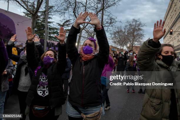 Women's rights supporter give a feminist hand symbol during a gathering after a mural celebrating a diverse array of women was vandalized today with...