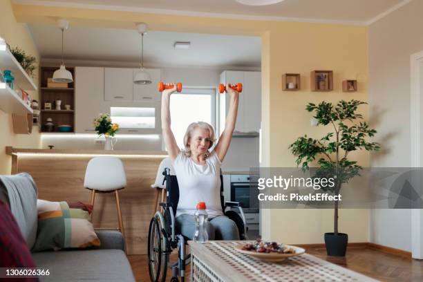 keeping herself fit - wheelchair sport stock pictures, royalty-free photos & images