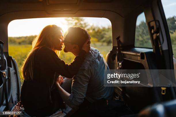kus onder perfecte zonsondergang - kissing stockfoto's en -beelden
