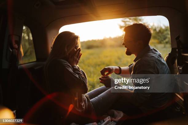 romantic proposal under the warmth of spring sunset - surprise marriage proposal stock pictures, royalty-free photos & images
