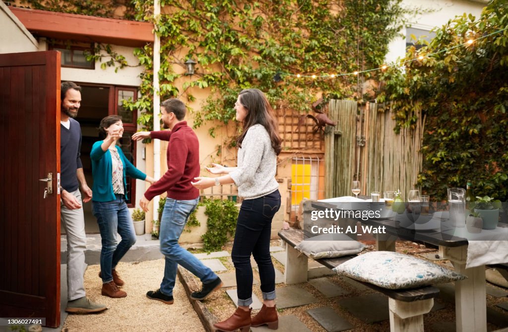 Couple welcoming guests for party