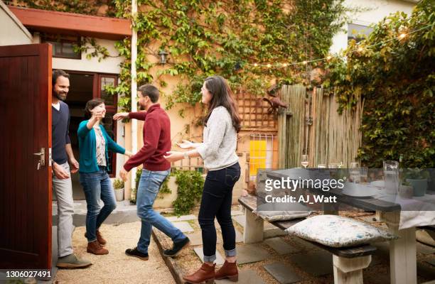couple welcoming guests for party - party host imagens e fotografias de stock