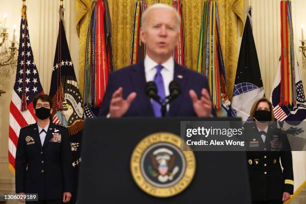 President Joe Biden delivers remarks on International Women’s Day as Air Force General Jacqueline Van Ovost and Army Lieutenant General Laura...