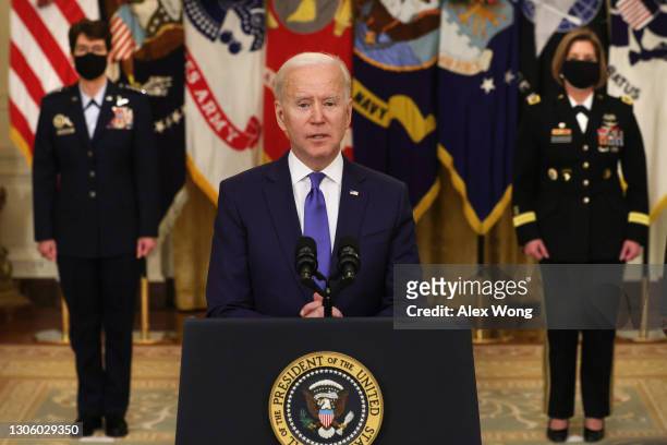 President Joe Biden delivers remarks on International Women’s Day as Air Force General Jacqueline Van Ovost and Army Lieutenant General Laura...