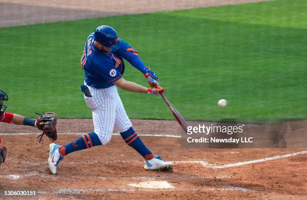 New York Mets' Pete Alonso hits a grand slam in the fifth inning of a spring training game against the Washington Nationals at Clover Park in Port...