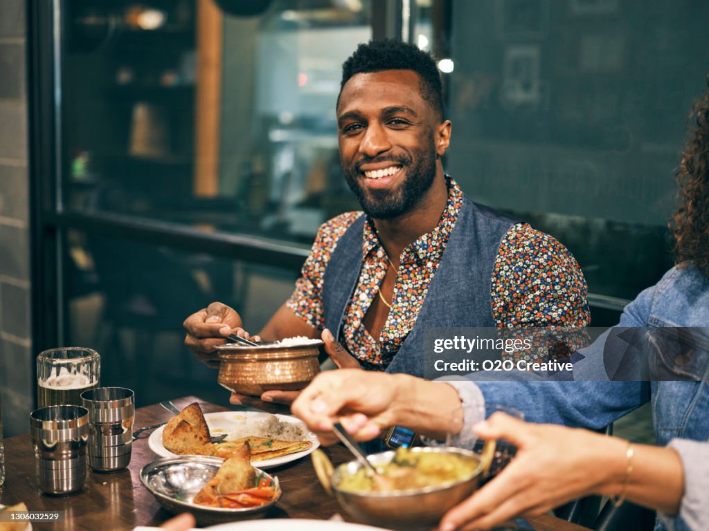 Multi Ethnic Group of Friends in an Indian Restaurant